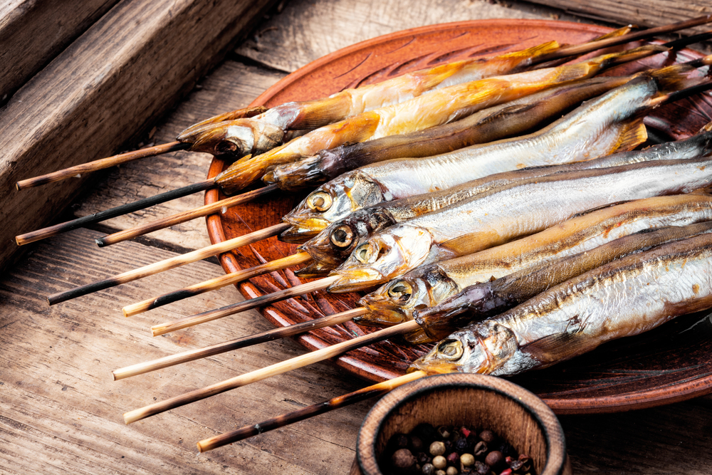 Smoked fish with spices.Smoked capelin.Traditional beer snack. Appetizing smoked fish