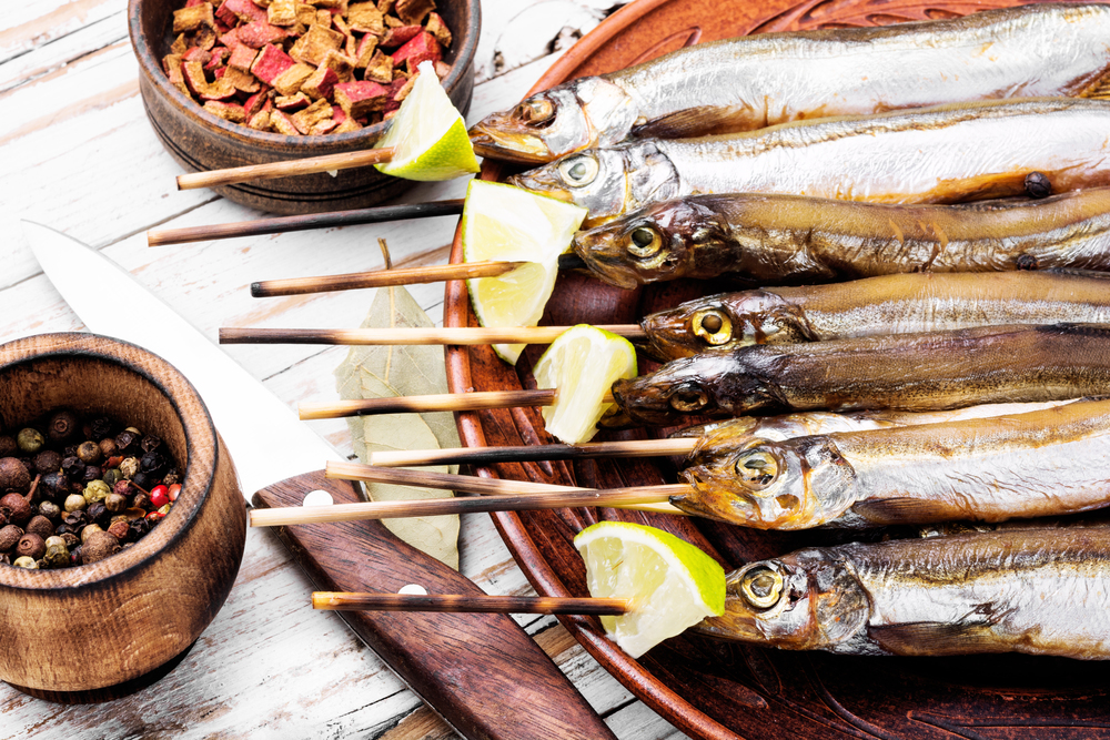 Smoked fish with spices.Cold smoked fish.Smoked capelin. Appetizing smoked fish