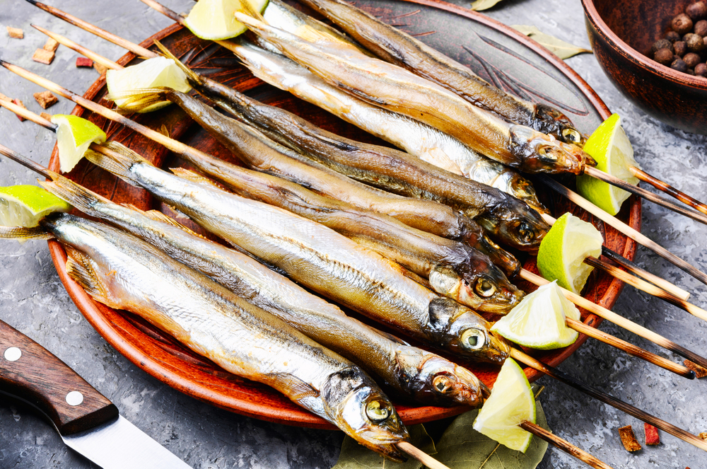 Smoked fish with spices.Cold smoked fish.Smoked capelin.Traditional beer snack. Appetizing smoked fish