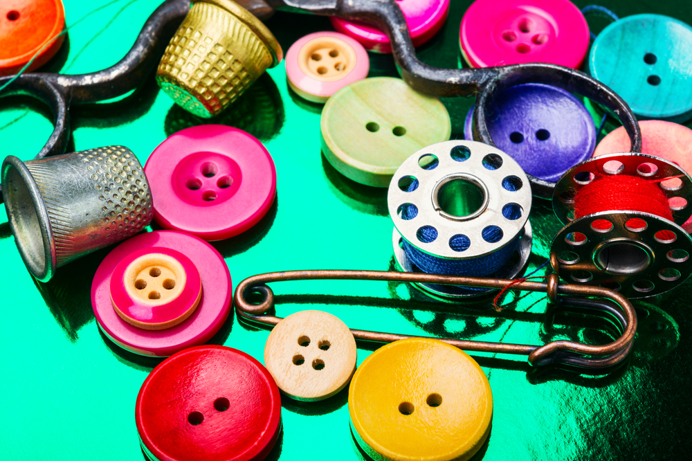 Accessories for tailoring.Bright assorted sewing buttons in mix colors. Set of tailoring accessories