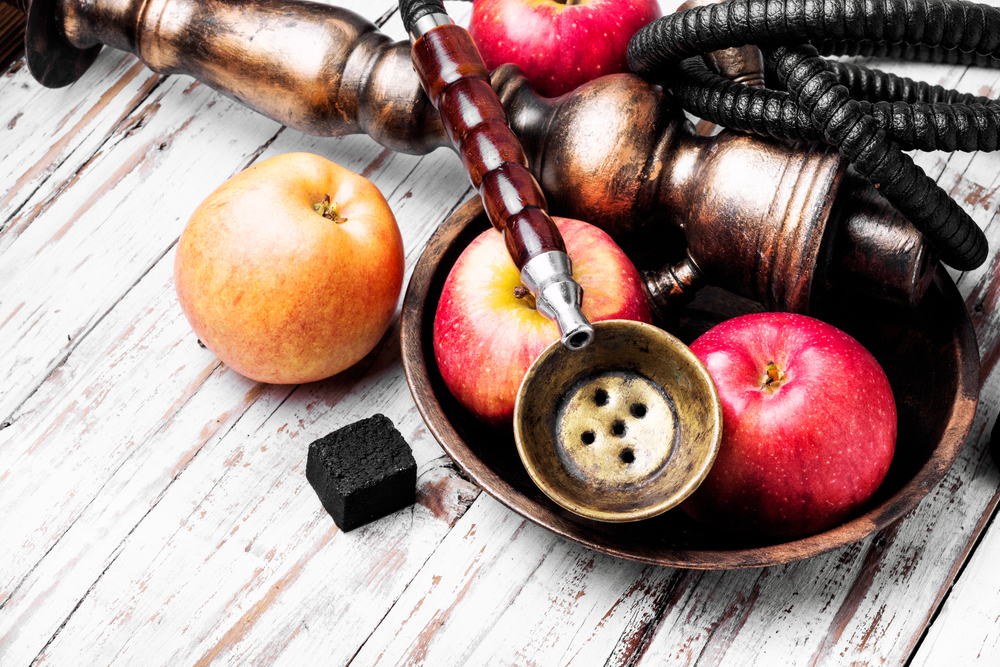 Oriental smoking hookah with mouthpieces with apple flavor.Shisha advertising. Persian hookah with aroma apple