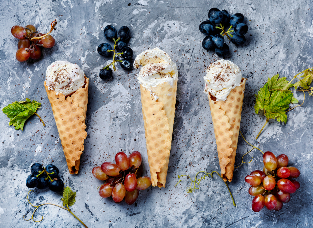 Ice cream cone vanilla and grape flavor. Summer menu concept. Grape flavored ice cream