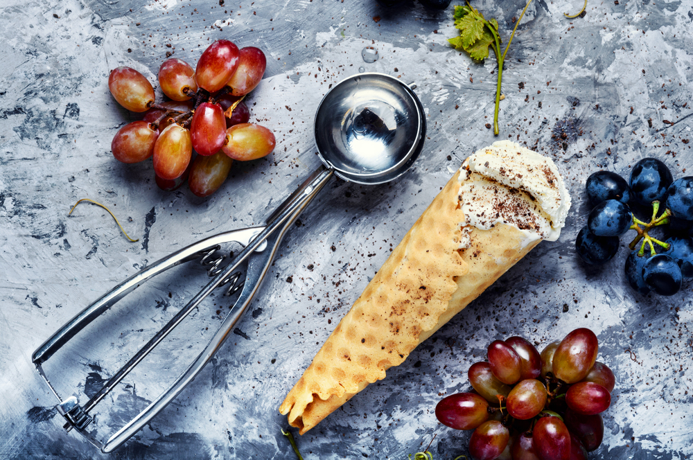 Ice cream cone vanilla and grape flavor. Summer menu concept. Grape flavored ice cream