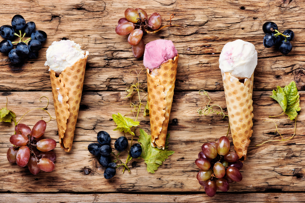 Ice cream sundae, waffle cone.Grape ice cream.Ice cream cones on wooden table. Grape flavored ice cream