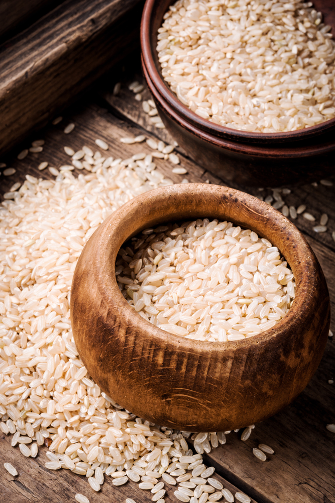 Uncooked dry rice in bowl.Thailand Rice in wooden bowl. Wooden bowl with rice