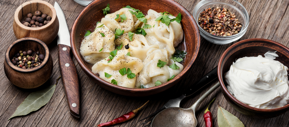 Delicious dumplings in the bowl on the table. Russian pelmeni meat