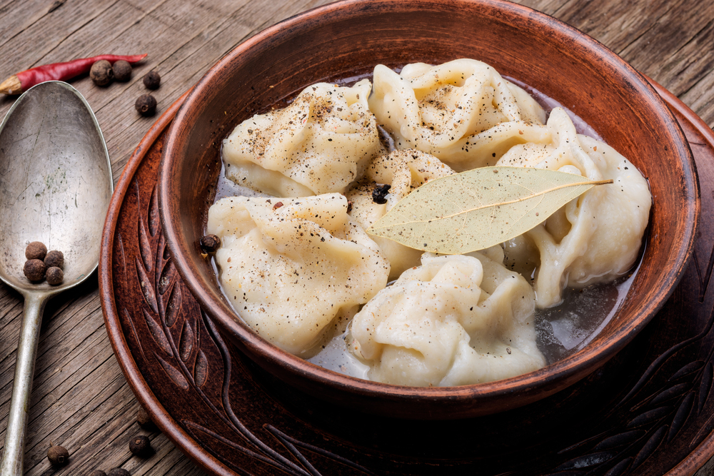 Delicious dumplings in the bowl on the table.Asian dumplings in bowl. Fresh boiled dumplings