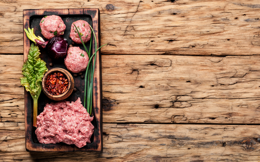 Minced meat on vintage wooden background.Raw chopped meat. Raw ground beef