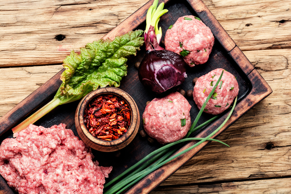 Minced meat on vintage wooden background.Raw chopped meat. Raw minced meat