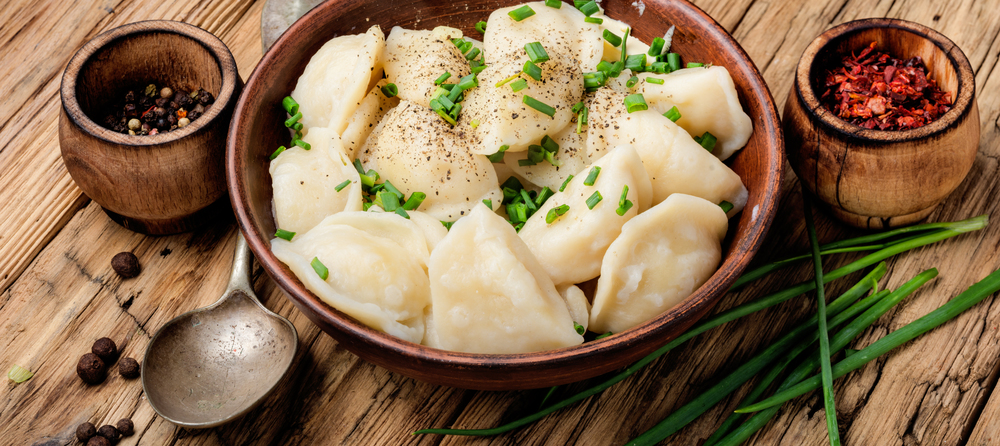 Dumplings is a Slavic dish, common in Ukrainian cuisine, in the form of boiled unleavened dough stuffed with vegetables. Dumplings with potatoes in plate