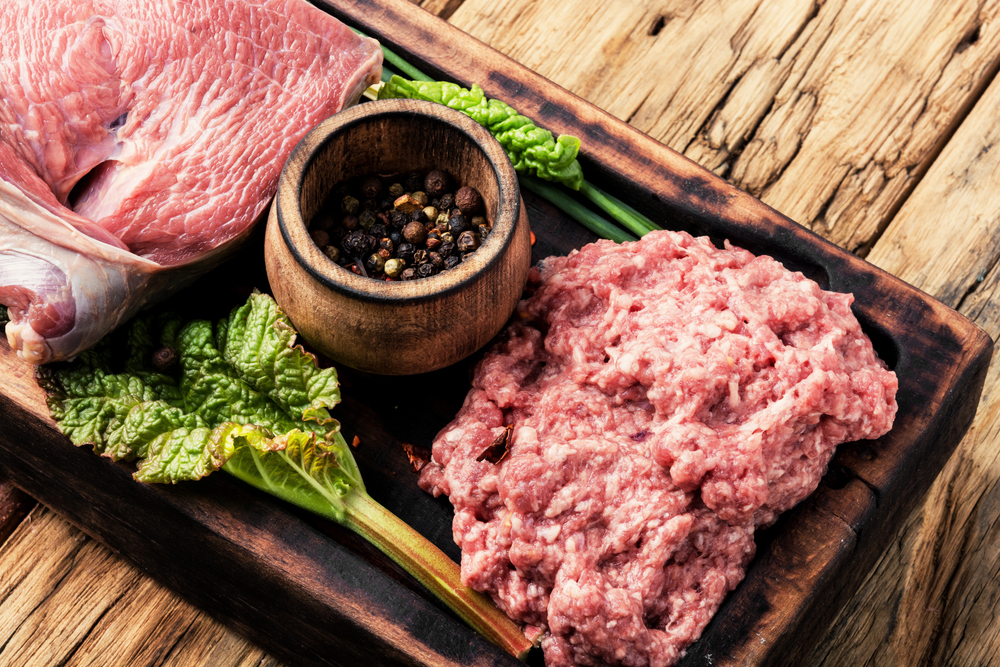 Fresh raw minced beef ground beef on old wood background. Raw minced meat