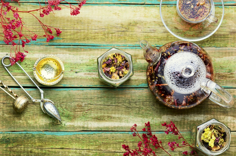 Healthy flower tea in a glass teapot.Natural herbs medicine. Herbal flower tea