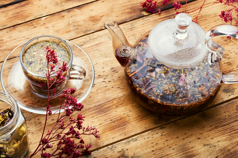 Glass teapot and cup with flower tea. Delicious herbal tea