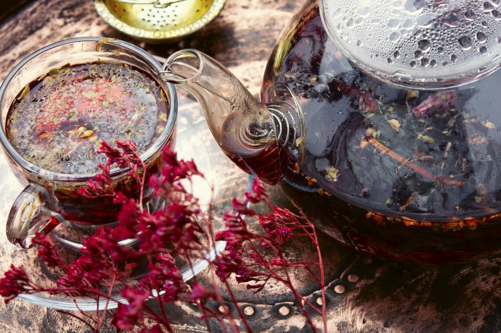 Fragrant flower tea in a glass teapot. Herbal flower tea