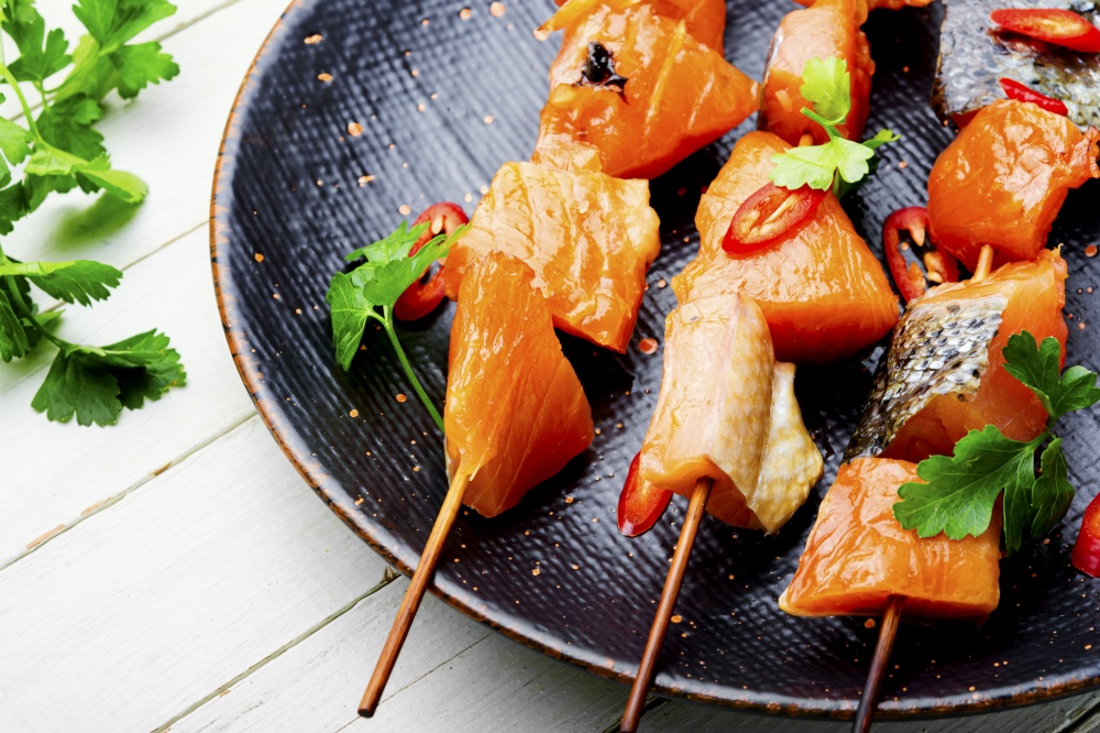 Appetizing pieces of dried salted salmon on skewers.Salty red fish. Dried fish salmon
