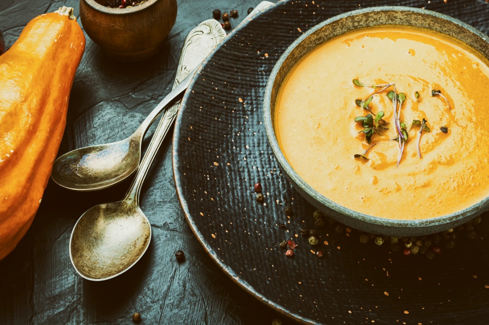 Vegetarian pumpkin cream soup.Bowl of autumn vegan pumpkin soup.. Tasty pumpkin creamy soup in bowl