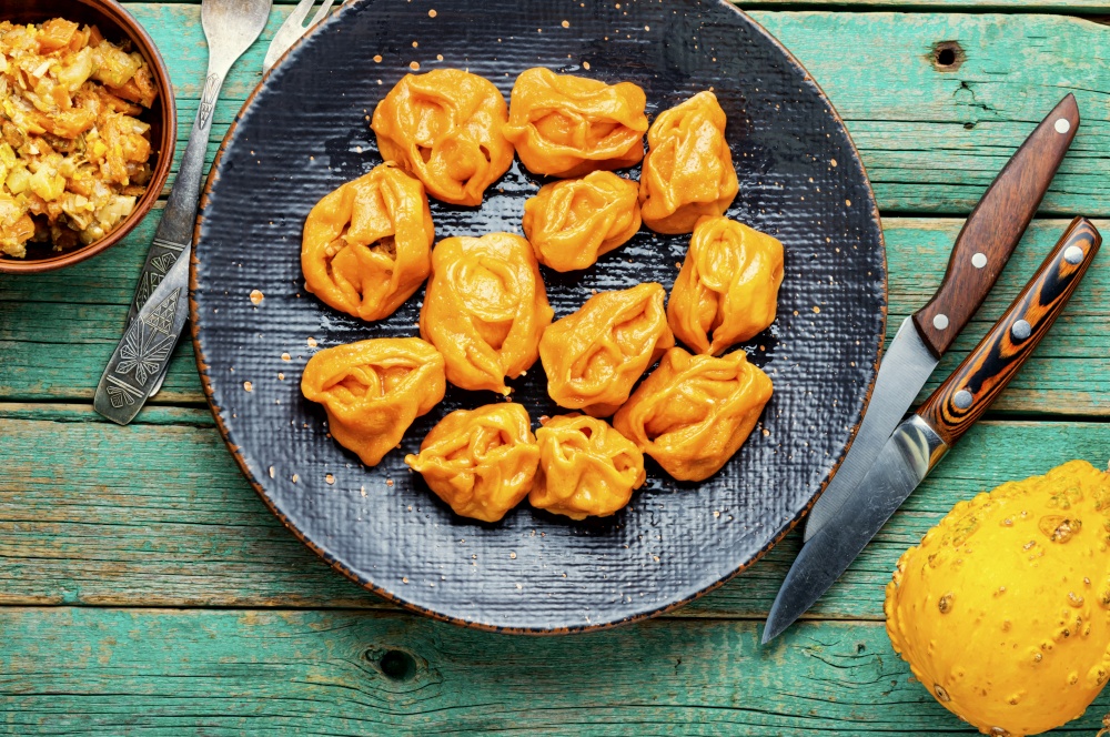 Steamed dumplings or manti with pumpkin.Kazakh manti with pumpkin. Boiled dumplings with pumpkin.