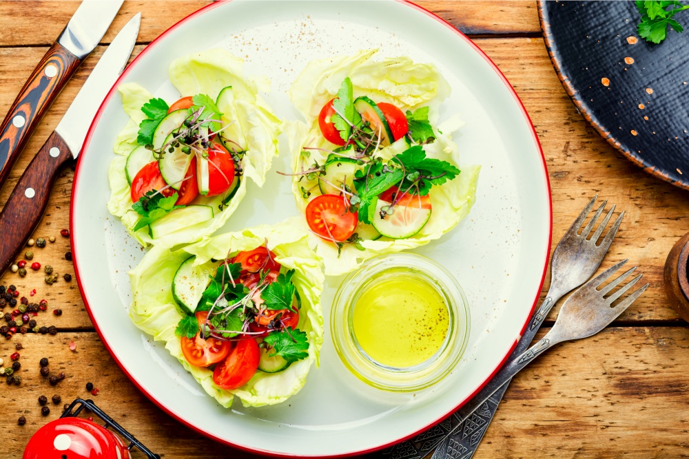 Vegetable spring salad with cabbage,cucumber,tomato and herbs.Healthy vegetable salad. Spring vegetable salad on wooden table