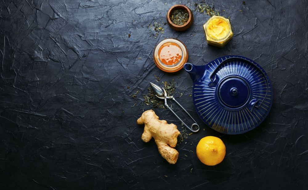 Teapot with ginger tea and honey.Vitamin,healing tea.Healthy ginger tea with lemon.Alternative medicine. Ginger root tea