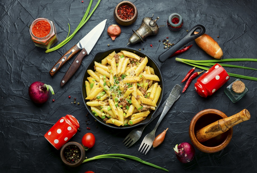 Skillet of pasta with fried minced meat.Soviet folk dish. Appetizing pasta with minced meat