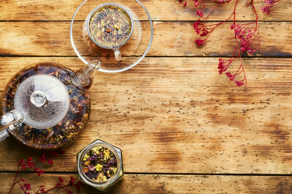 Fragrant flower tea in a glass teapot.Space for text. Herbal flower tea