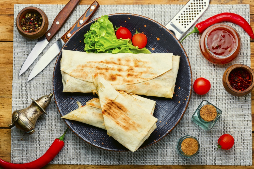 Shawarma,Middle Eastern dish made from fried chicken meat wrapped in pita bread. Shawarma sandwich on plate