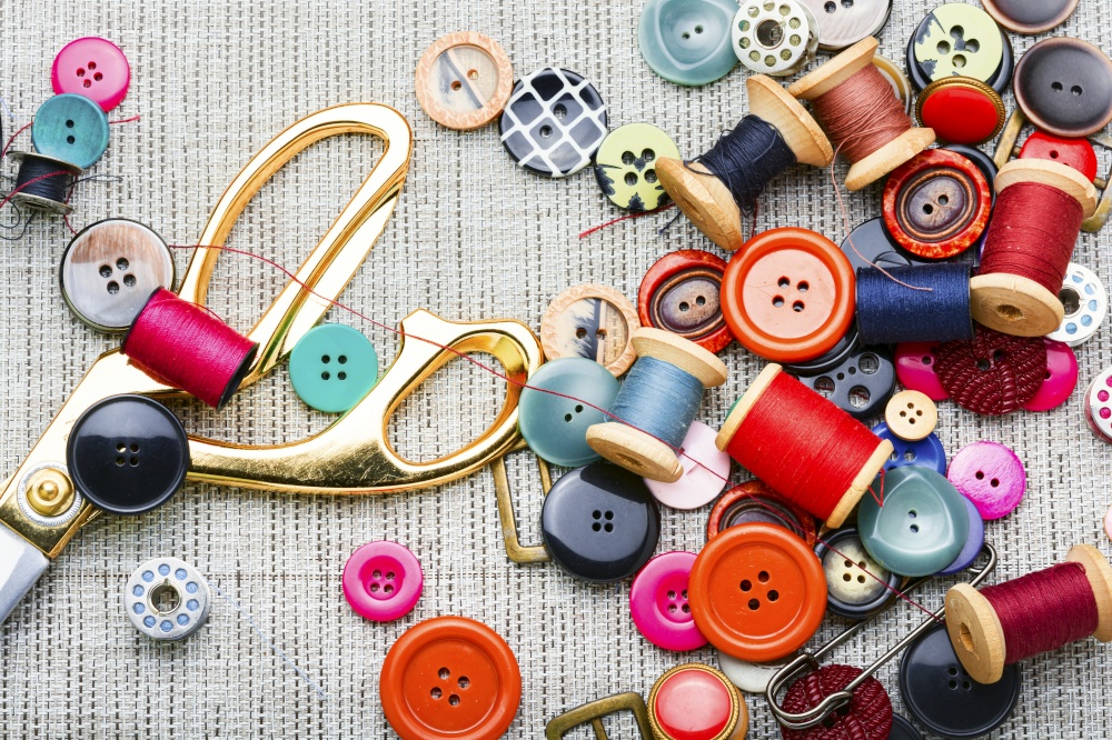 Set of buttons,spools of thread and other sewing accessories. Set sewing supplies,flat lay