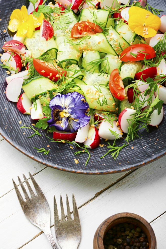 Spring salad with vegetables and edible flowers.Dieting concept.Organic nutrition. Green vegan salad