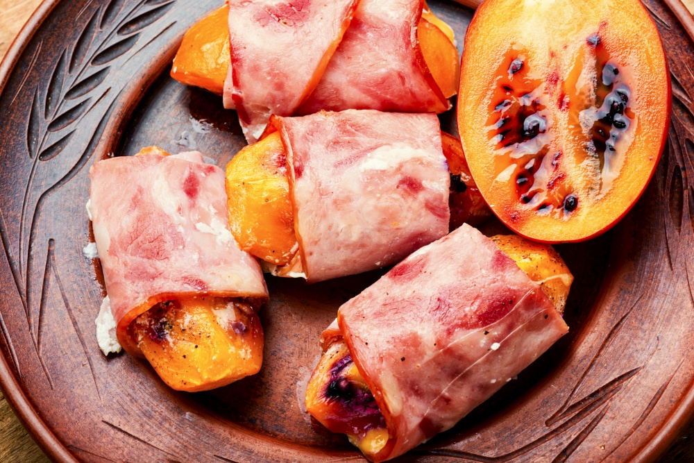 Tamarillo pieces wrapped and baked with ham and bacon. Baked ham with tamarillo