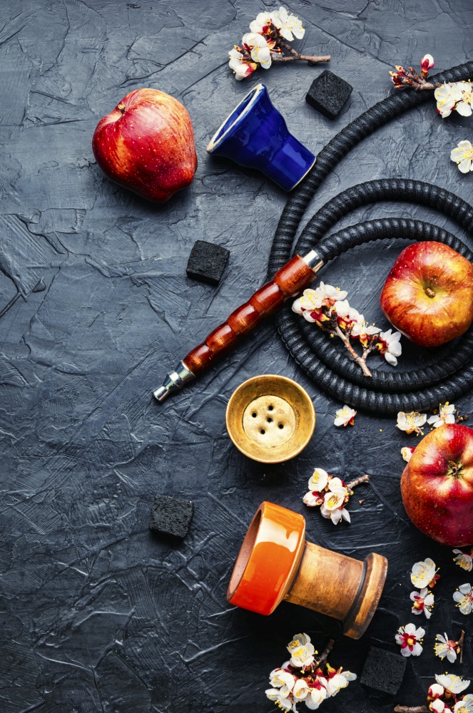 Modern shisha hookah on tobacco with apple tasty.Apple shisha.Smoking a hookah. Eastern hookah shisha with apple,smoking hookah
