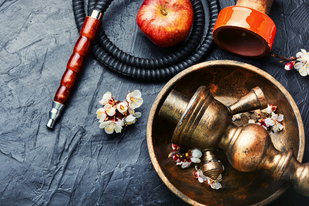 Modern shisha hookah on tobacco with apple tasty.Apple shisha.Smoking a hookah. Smoking hookah with apple flavor