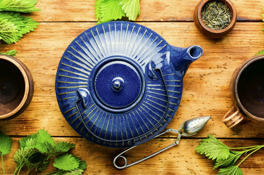 Fresh herbal tea with nettle leaves.Herbal medicine,homeopathy.Tea drinking. Herbal tea with nettle