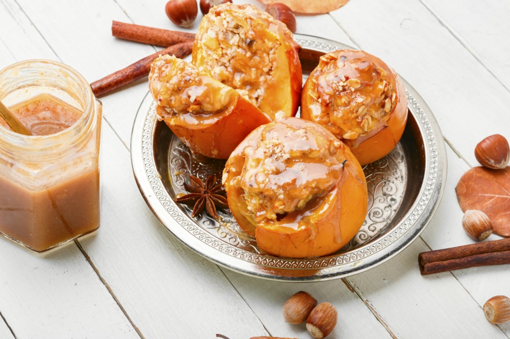 Persimmon stuffed with oatmeal with caramel sauce.Baked persimmon.Closeup photo. Baked stuffed persimmon