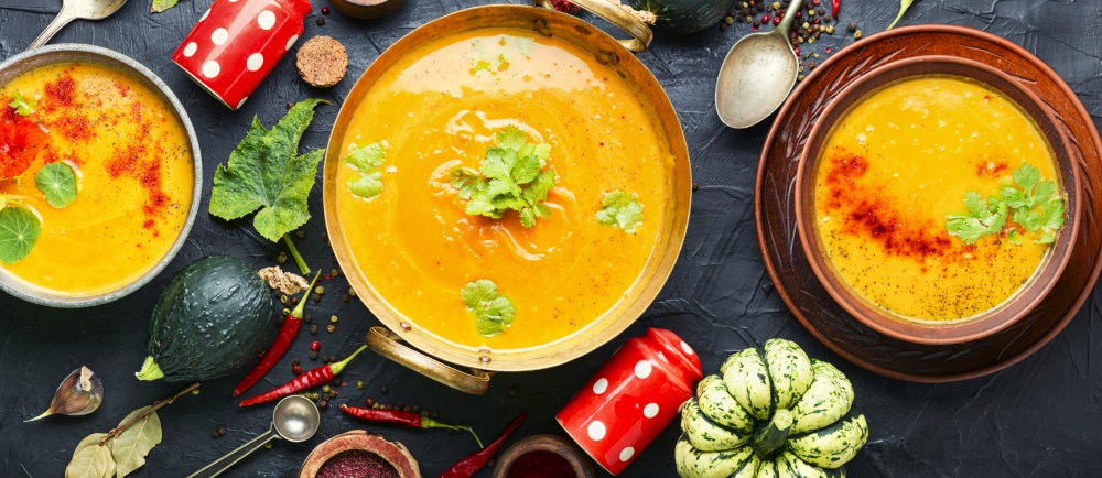 Delicious pumpkin soup and pumpkins.Homemade autumn soup. Autumn pumpkin soup