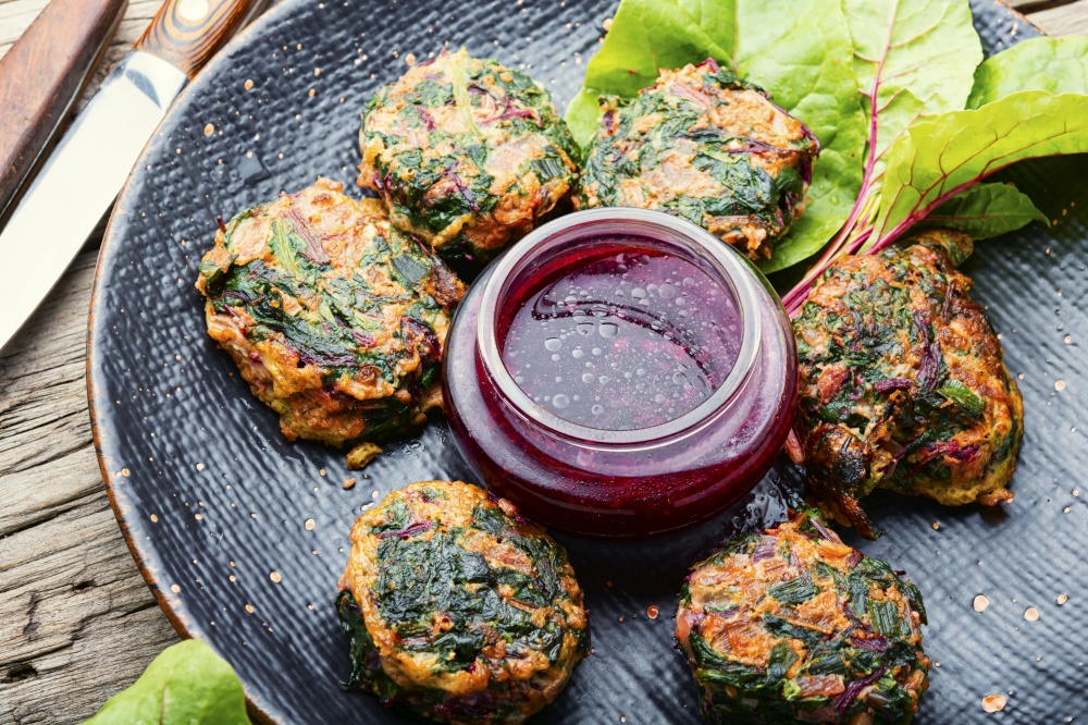 Tasty homemade chard cutlets.Vegetarian cutlets with fruit sauce.Healthy diet. Healthy herb vegetarian cutlets on the plate