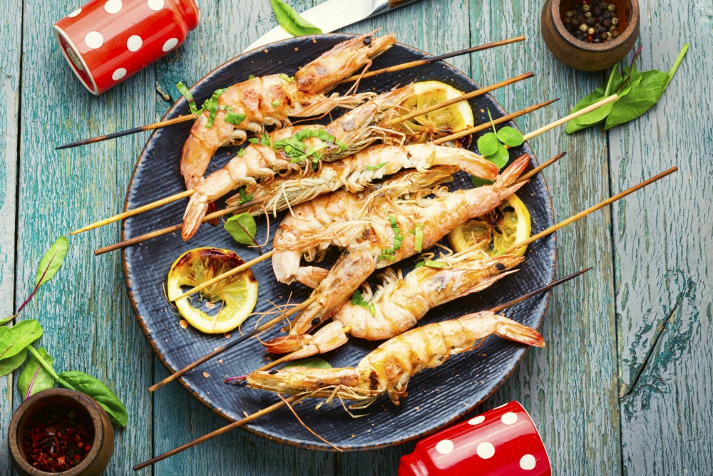 Grilled langoustines,prawn roasted on a skewer.Langoustines fried with herbs. Large langoustines on a plate