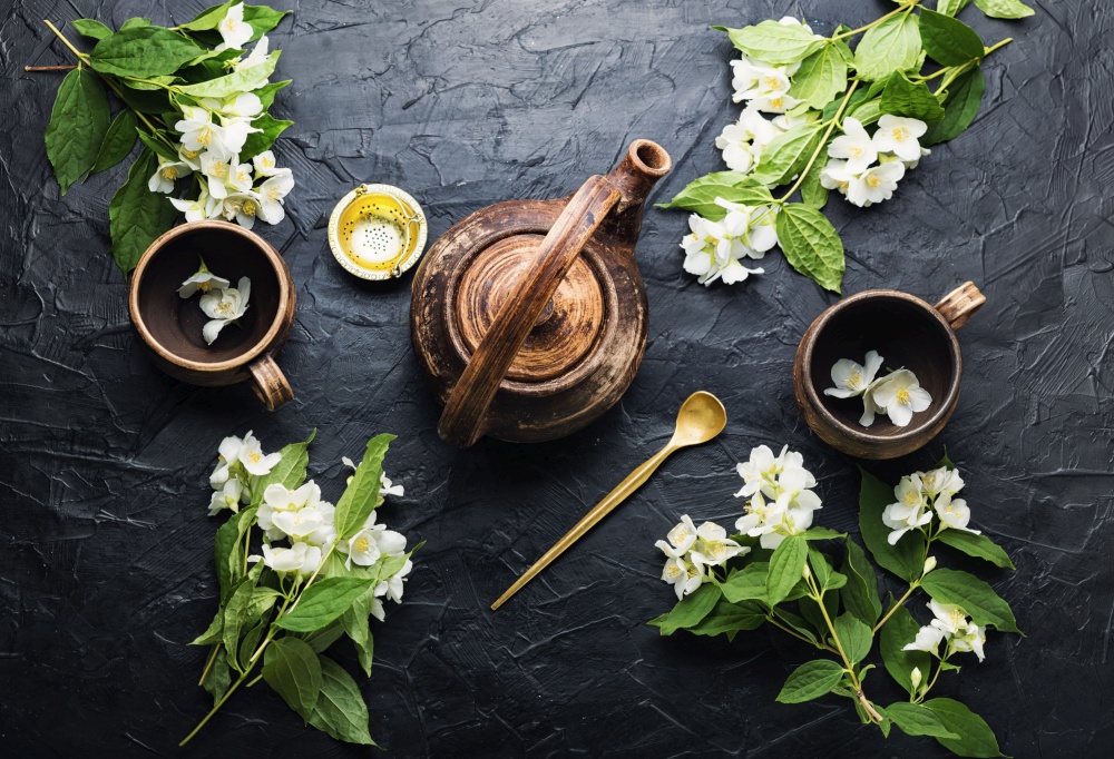 Clay tea cups and teapot.Jasmine flower tea herbal tea.Herbal medicine.. Jasmine flower tea