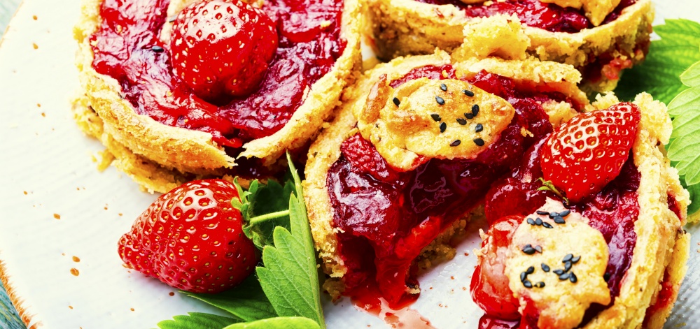 Yummy tartlets with berry jam.Cake with strawberries.Fruit dessert. Summer tartlets with strawberries