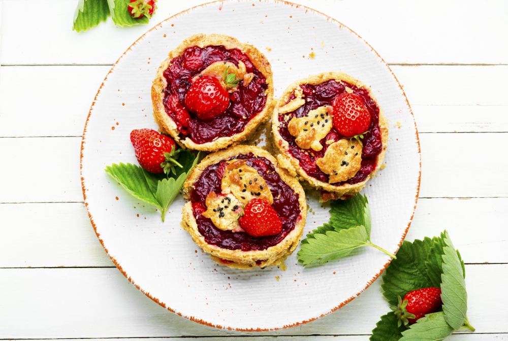Strawberry shortcake pies.Tasty tartlets with fresh strawberries.Sweet dessert on white background. Summer biscuit or shortcake with strawberries