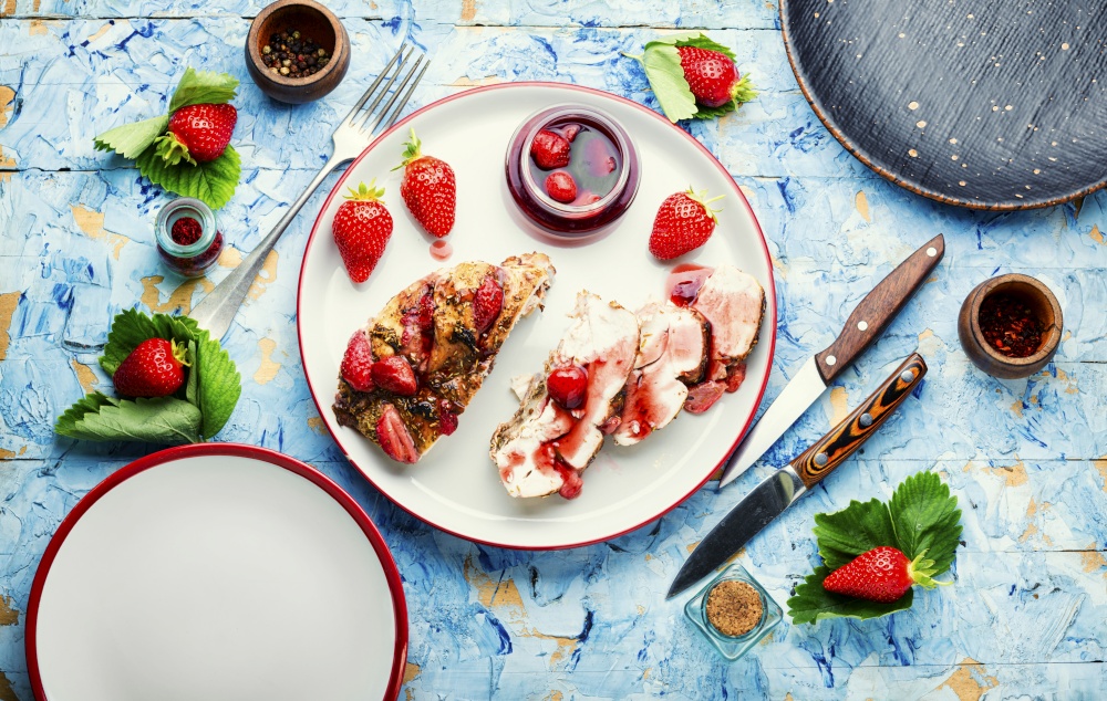 Delicious chicken breast roasted with berry Chicken meat baked with strawberries.Healthy food. Chicken meat baked in strawberry sauce,top view