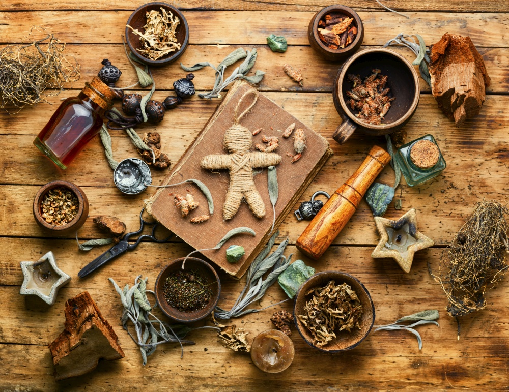 Voodoo doll, magical herbs and witchcraft attributes on an old table. Voodoo doll,a doll used in witchcraft