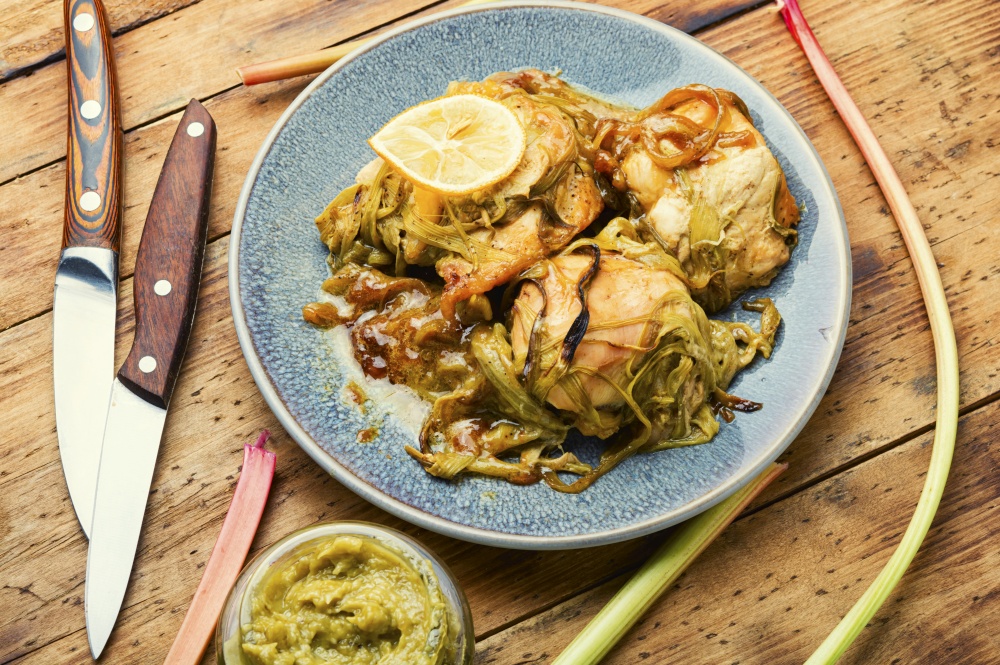 Delicious baked chicken meat with rhubarb stalks. Chicken breast with rhubarb sauce.. Appetizing chicken breast baked with rhubarb