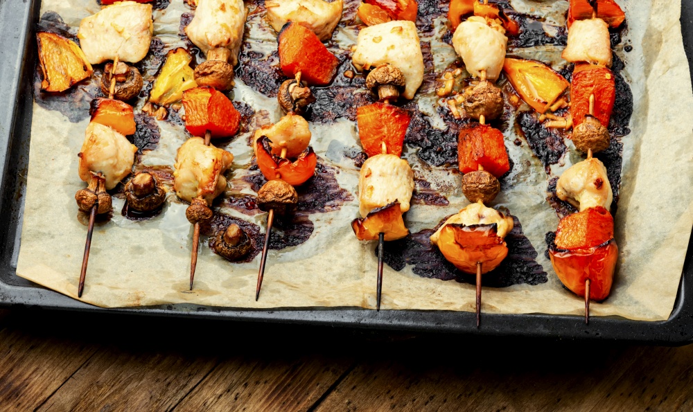 Chicken fillet pieces with mushrooms and pumpkin on wooden skewers. Kebab,chicken and grilled vegetables