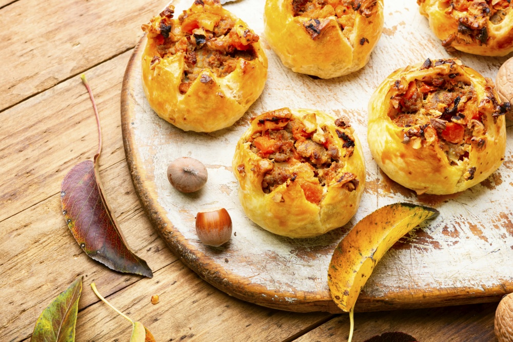 Autumn delicious buns stuffed with pumpkin and meat.Homemade pastry with pumpkin. Autumn bun or pumpkin pie