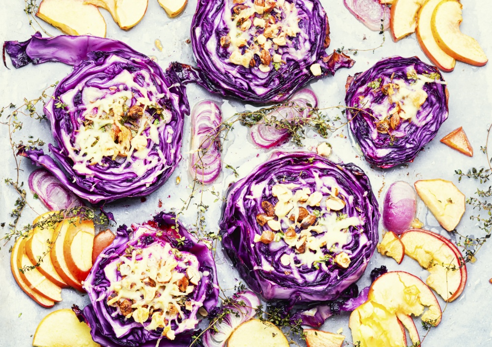 Vegan autumn dish of red cabbage, apples and nuts. Healthy appetizer. Baked vegan red cabbage steaks. Roasted red cabbage steaks, autumn food