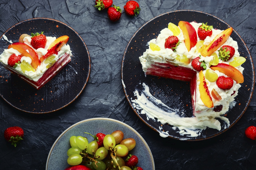 Symbolic summer watermelon pie with fruit and whipped cream.. Summer cake with watermelon and berries.