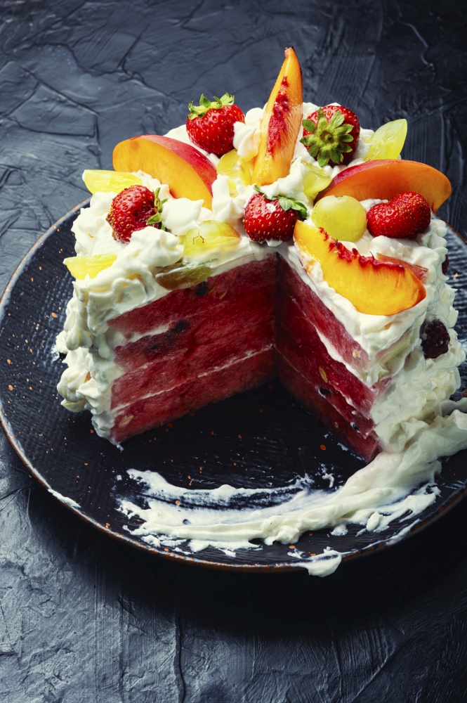 Delicious summer watermelon pie with fruit and whipped cream.. Summer cake with watermelon and berries.