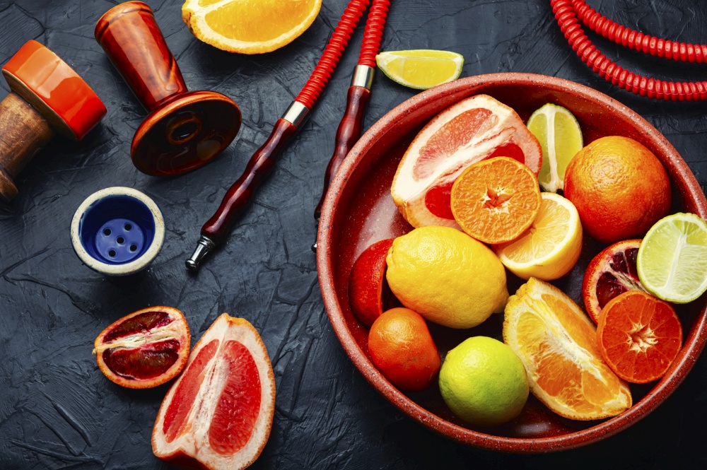 Fragrant smoking hookah or shisha with tobacco from citrus fruits.. Eastern with citrus tobacco, smoking
