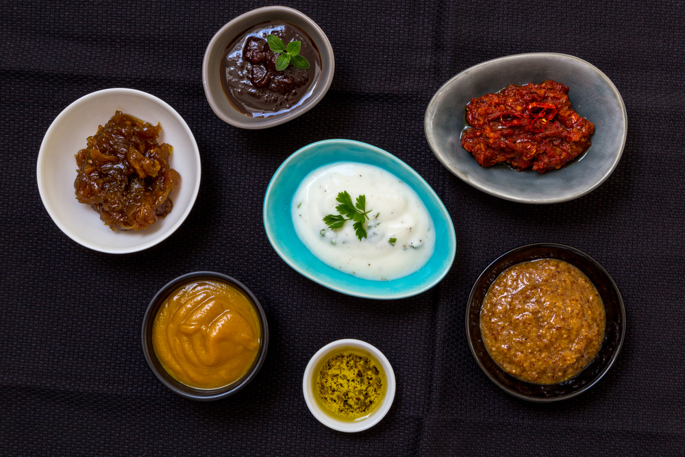 Variation of sauces and dips on wood background.. Variation of sauces and dips on wood background