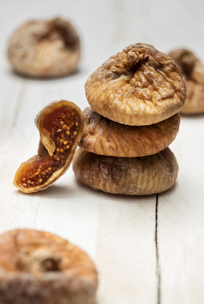 Dried figs on a white wooden background.. Dried figs on a white wooden background